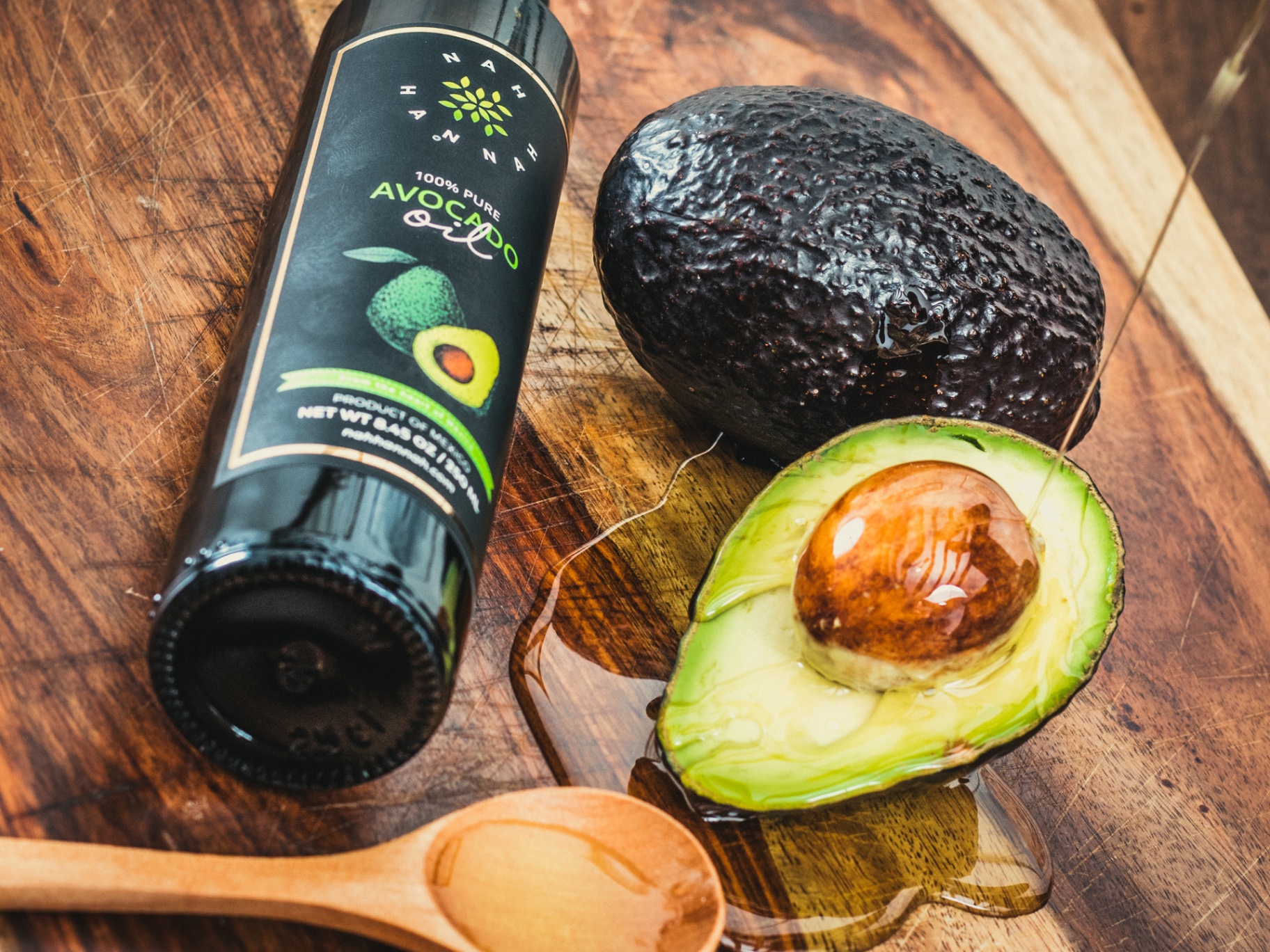 Hass avocado alongside Nah Hannah oil
